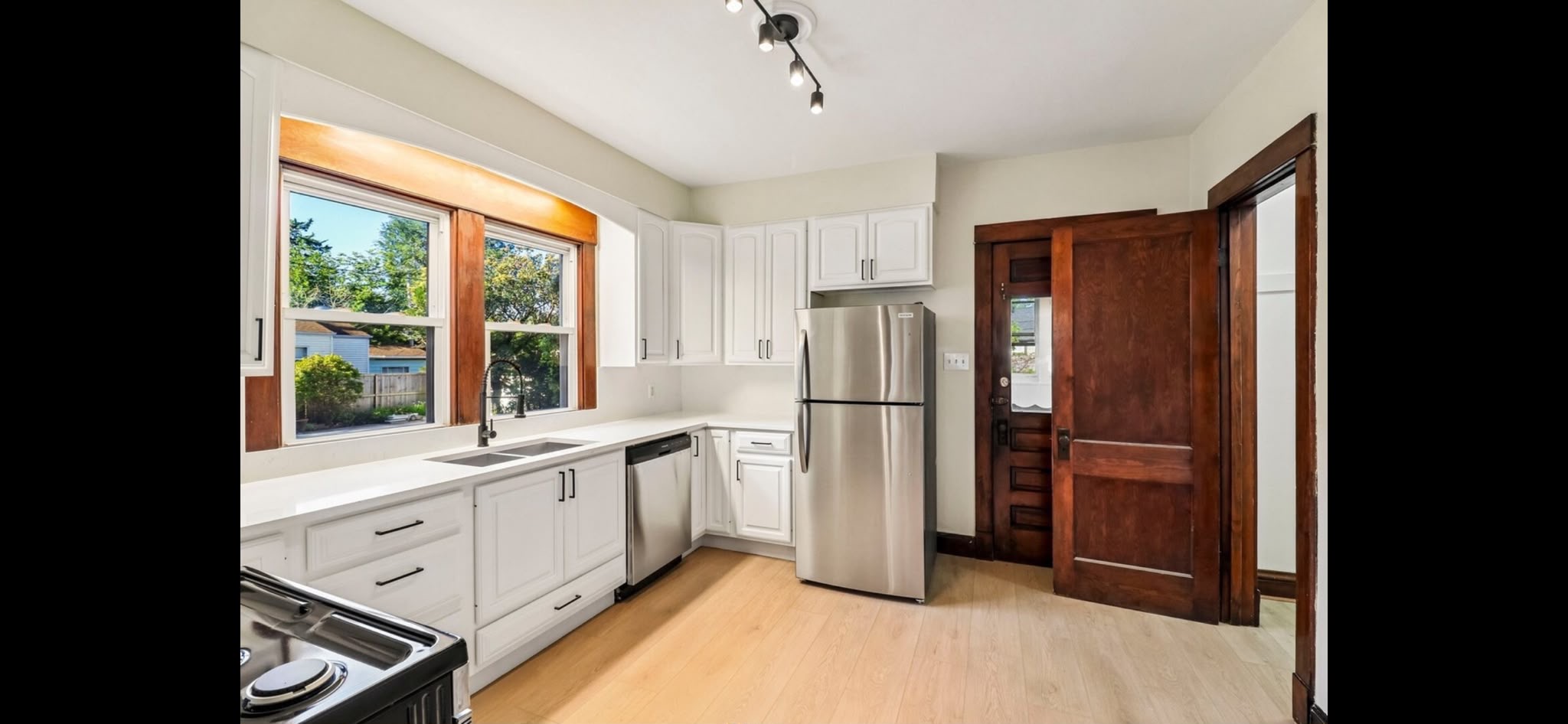 Kitchen with refreshed white cabinets