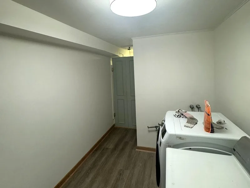 Finished laundry room from the opposite end showing clean painted walls and trim